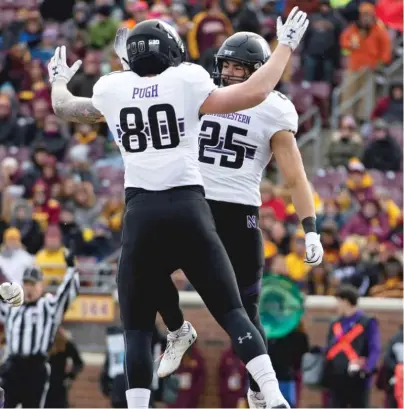  ?? AP ?? Northweste­rn running back Isaiah Bowser celebrates one of his two touchdown runs Saturday with teammate Trey Pugh.