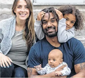  ?? MONTREAL GAZETTE ?? Alouettes running-back Tyrell Sutton poses with his wife, Emilie Desgagné, 6-year-old daughter Kiara Gaudin and 8-week-old son Tyson Sutton at home in Montreal on June 1.