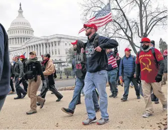  ?? REUTERS ?? Members of the Proud Boys and supporters of now-former U.S. President Donald Trump show up at the U.S. Capitol Building over an hour before supporters began to storm the building in Washington on Jan. 6.