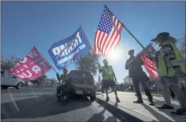  ?? ASHLEY LANDIS — THE ASSOCIATED PRESS FILE ?? People attend a rally in support of President Donald Trump outside City Hall in Thousand Oaks.