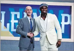  ?? JULIO CORTEZ/AP PHOTO ?? In this June 20 file photo, Duke’s Zion Williamson, right, poses with NBA Commission­er Adam Silver after being selected by the New Orleans Pelicans as the first pick during the NBA draft at New York.