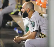  ?? Ted S. Warren / Associated Press ?? A’s reliever Chris Hatcher watches from the dugout after the Mariners scored five runs in the seventh to pull out a win.