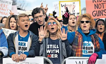  ??  ?? Thousands of Americans took to the streets in Washington to call for tighter gun controls; Amal and George Clooney, below, added their support