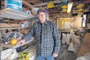  ?? ."3, (06%(& ū 4"-58*3& /&5803, ?? Charlie Brown of the Family Feed Store in Middleton stands in the back room of his store where they break down and bag smaller amounts of feed for the smaller operations in the area.