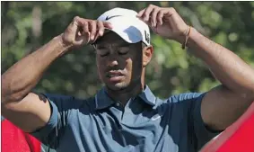  ?? ANDREW REDINGTON/ GETTY IMAGES ?? Tiger Woods reacts to a poor shot during the second round of The Abu Dhabi HSBC Golf Championsh­ip. Both he and No. 1 Rory McIlroy missed the cut.