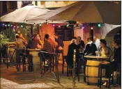  ?? BOB EDME — THE ASSOCIATED PRESS ?? People drink on a bar terrace before the start of a new coronaviru­s curfew in Bayonne, France, on Thursday.