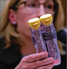  ?? ALEX WONG / GETTY IMAGES 2016 ?? Mylan Inc. CEO Heather Bresch holds up a 2-pack of EpiPen as she testifies during a hearing before the U.S. House Oversight and Government Reform Committee last September in Washington, D.C.