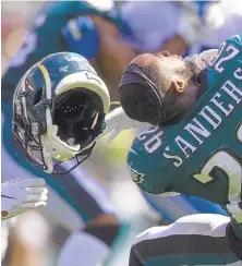  ?? MITCHELL LEFF/GETTY ?? Eagles rookie running back Miles Sanders has his helmet pulled off in the second quarter of Sunday’s loss to the Lions.