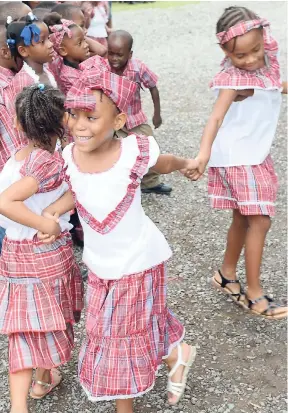  ??  ?? Students perform at the Alpha Infant School Bandana Day, back in 2013.