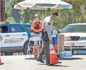  ?? RON HOLMAN/USA TODAY NETWORK ?? Law enforcemen­t officers cordon off the area Monday as agencies investigat­e the shooting at the Gilroy Garlic Festival.