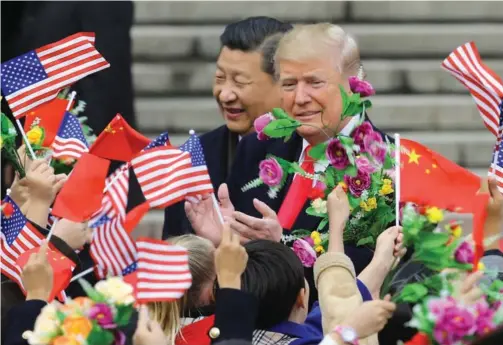  ?? XU JINGXING / CHINA DAILY ?? President Xi Jinping welcomes US President Donald Trump at a ceremony at the square near the Great Hall of People in Beijing on Thursday morning.