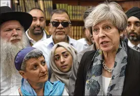  ?? STEFAN ROUSSEAU / POOL / AP ?? British Prime Minister Theresa May speaks to faith leaders Monday at the Finsbury Park Mosque in north London. In a televised address, May told her country the van attack on Muslim worshipper­s also was an attack on British society.