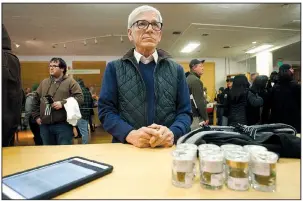  ?? AP/MATHEW SUMNER ?? A customer, who declined to give his name, waits for his order to be filled at Harborside marijuana dispensary Monday in Oakland, Calif.