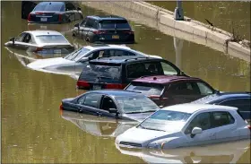  ?? AP PHOTO/CRAIG RUTTLE ?? Cars are stranded by high water Thursday on the Major Deegan Expressway in Bronx borough of New York as high water left behind by Hurricane Ida still stands on the highway hours later.