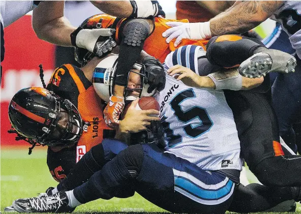  ?? GERRY KAHRMANN/PNG FILES ?? B.C. Lions’ Solomon Elimimian gets a little rough with Toronto Argonauts quarterbac­k Ricky Ray during their July 7 CFL game at B.C. Place Stadium. Ray won that contest 25-14 but the two will renew their rivalry on Wednesday at BMO Field in Toronto.