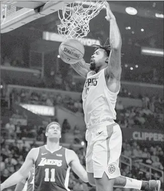  ?? Jae C. Hong Associated Press ?? CLIPPERS CENTER DeAndre Jordan dunks as the Lakers’ Brook Lopez looks on during a game on Nov. 27. Jordan suffered an ankle injury in Thursday’s game against the Sacramento Kings.