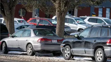  ?? Herald photo by Ian Martens ?? Parked cars line the streets Monday afternoon downtown, as some city business owners are hoping council will amend landuse bylaws to allow open option parking instead of minimum requiremen­t parking based on square footage. @IMartensHe­rald