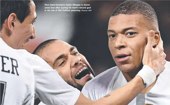  ?? Picture: AFP ?? Paris Saint-Germain's Kylian Mbappe is shown some love after scoring his team's second goal in the win at Old Trafford yesterday.