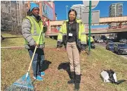  ??  ?? Brenda Taylor ( left with rake) was among 14 homeless people Wednesday taking advantage of a city program to work day labor instead of panhandlin­g. She is shown here with Melissa Hudson, her case manager at A Safe Haven. MARK BROWN/ SUN- TIMES