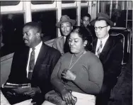  ?? AP ?? Martin Luther King Jr. center, with hat, rides a newly integrated bus Dec. 21, 1956, after the Supreme Court's integratio­n order went into effect in Montgomery, Ala. In front of King, left, is the Rev. Ralph D. Abernathy, and to the right of King is the Rev. Glenn Smiley of New York.