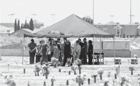  ?? Jorge Salgado / Associated Press ?? Family and friends gather for a funeral service Saturday for Jordan Anchondo at Evergreen Cemetery in El Paso. Anchondo and her husband, Andre, were among the 22 people killed Aug. 3, when a gunman opened fire inside a Walmart.