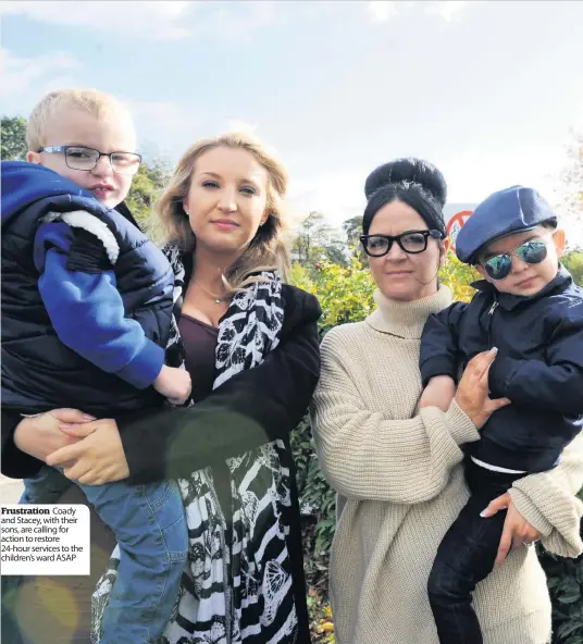  ??  ?? Frustratio­n Coady and Stacey, with their sons, are calling for action to restore 24-hour services to the children’s ward ASAP