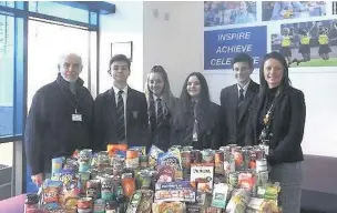  ??  ?? Pupils at Poynton High School donated tinned food and goods to a local food bank, which has seen demand increase