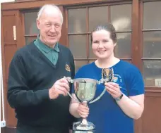  ??  ?? Left — Dundee University with the Handicap Cup they won by beating their Abertay rivals. Right — Dundee University captain Stephanie Scott Flynn being handed the winning trophy by Dundee and District Badminton Associatio­n chairman Bill Garland. More...