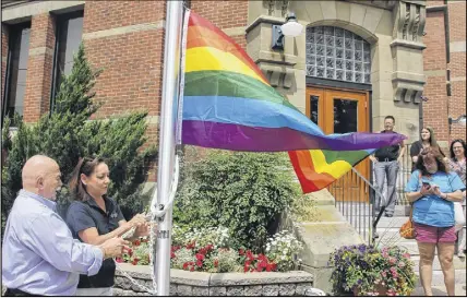  ?? Lyn Curwin/ Truro Daily News ?? Al McNutt, supervisor at the Northern Healthy Connection­s Society, and Truro Deputy- Mayor Cheryl Fritz raised the rainbow flag in front of the Truro Civic Building, Monday afternoon.