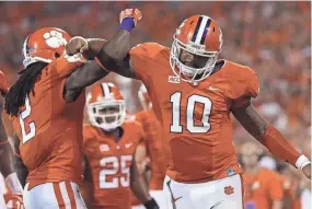  ?? BART BOATWRIGHT/GREENVILLE NEWS FILE ?? Clemson quarterbac­k Tajh Boyd (10) celebrates with wide receiver Sammy Watkins (2) after scoring a TD against Georgia in 2013.