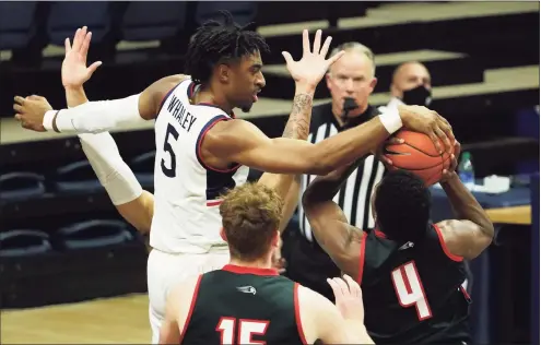  ?? David Butler II / USA Today ?? Hartford Hawks guard Moses Flowers (4) shoots against UConn Huskies forward Isaiah Whaley (5) in the first half at Harry A. Gampel Pavilion on Friday in Storrs.