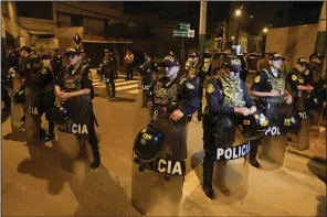  ?? (AP/Martin Mejia) ?? Police guard the outside of President Dina Boluarte’s house during a raid ordered by the attorney general’s office aimed at seizing Rolex watches as part of a preliminar­y investigat­ion into alleged illicit enrichment in Lima, Peru, on Saturday.