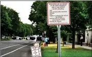  ?? AP/Pioneer Press/JEAN PIERI ?? Cleanup continues with new signs posted in front of the Governor’s Residence on Summit Avenue in St. Paul, Minn., on Wednesday after police arrested dozens of protesters Tuesday and early Wednesday as they sought to reopen the street.