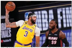  ?? (AP/Mark J. Terrill) ?? Anthony Davis (left) looks to throw a pass Wednesday against Jae Crowder during the first half of the Los Angeles Lakers’ 116-98 victory over the Miami Heat in Game 1 of the NBA Finals in Lake Buena Vista, Fla.