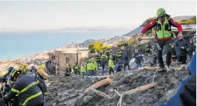  ?? Photo / AP ?? Rescuers at work after heavy rain triggered landslides in Casamiccio­la, on the Italian island of Ischia.