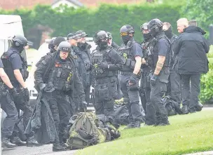  ??  ?? ●●Armed police pictured at the scene of the siege