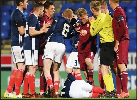  ??  ?? Scotland Under-21s were in for some rough treatment in the away leg in Latvia, with Aberdeen’s Scott Wright laid out during the match