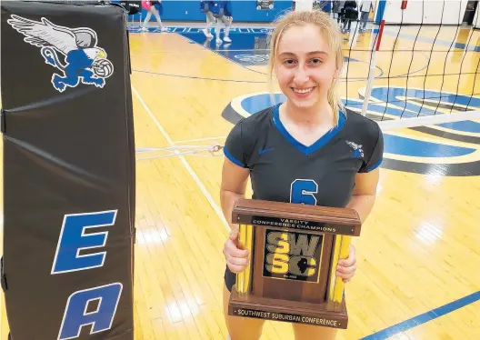  ?? TONY BARANEK/DAILY SOUTHTOWN ?? Lincoln-Way East’s Julia Owczarzak displays the SouthWest Suburban Blue championsh­ip plaque after a victory Thursday over Sandburg.