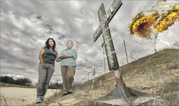  ?? Irfan Khan Los Angeles Times ?? MICHELLE GLENN, left, Miguel Ferreyra’s cousin, and his aunt Clara Trevino stand at a makeshift memorial near the Temecula home where Ferreyra, 31, and four other adults were found dead after an Aug. 29 fire.