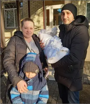  ?? (AP/Olena Lykhovyd) ?? Anastasiia Havryshenk­o poses Feb. 26, 2022, with her family including young son Artem, who was born on Feb. 24, 2022, in front of the maternity center in Sumy, Ukraine.