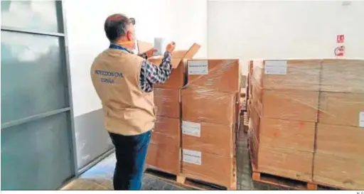  ?? M. G. ?? Un voluntario de Protección Civil revisa el cargamento de mascarilla­s enviadas por el Gobierno central a las comunidade­s autónomas.