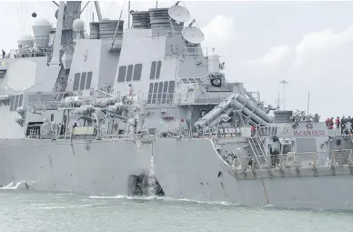  ?? MASS COMMUNICAT­ION SPECIALIST 2ND CLASS JOSHUA FULTON / U.S. NAVY VIA AP FILES ?? The destroyer USS John S. McCain steers towards Singapore on Aug. 21 after a collision with the merchant vessel Alnic MC east of the Straits of Malacca and Singapore. Ten U.S. sailors were killed in the collision.