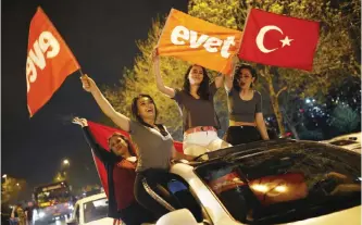  ??  ?? ISTANBUL: Supporters of the “Yes” vote in Turkey’s historic referendum wave flags during celebratio­ns yesterday. — AP