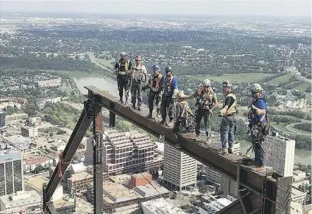  ??  ?? Members of Ironworker­s local 720 work on Edmonton’s Stantec Tower, Canada’s tallest office building outside Toronto, on Thursday. “You have to really like the heights,” says Keith Stevenson, business manager for the union.