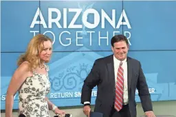  ??  ?? ROSS D. FRANKLIN/AP Arizona Department of Health Services Director Dr. Cara Christ and Gov. Doug Ducey announce the state’s latest coronaviru­s data.