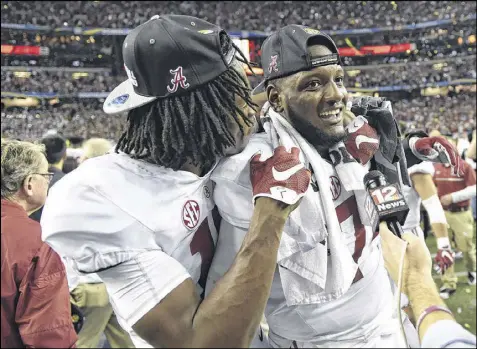  ?? DAVID BARNES / DAVIDBARNE­S@AJC.COM ?? Left tackle Cam Robinson (right, with receiver Cam Sims) says he noticed a decline in focus during Alabama’s 2014 postseason run — which ended with a loss to Ohio State in the semifinal game.