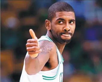  ?? MADDIE MEYER / AGENCE FFRENCE-PRESSE ?? Kyrie Irving of the Boston Celtics gives a thumbs-up during the first half of Monday’s 94-82 preseason victory over the Charlotte Hornets at TD Garden in Boston.