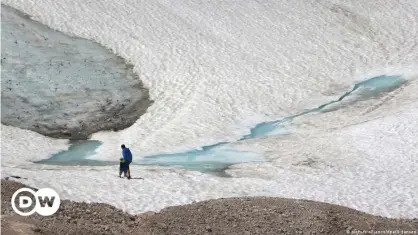 ??  ?? Walks like this on a glacier in the German Alps could be impossible in as little as 10 years