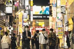  ?? HIRO KOMAE AP ?? People have begun to return to the famed Kabukicho entertainm­ent district in Tokyo as the government has lifted coronaviru­s states of emergency.