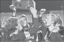  ?? SHAWN MCFARLAND/HARTFORD COURANT ?? Hand lifts the Class L state championsh­ip trophy. The Tigers have won four straight titles.